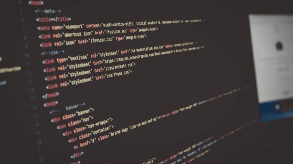 Website Design for Small Businesses by Deacon Solutions with custom web development code displayed on screen